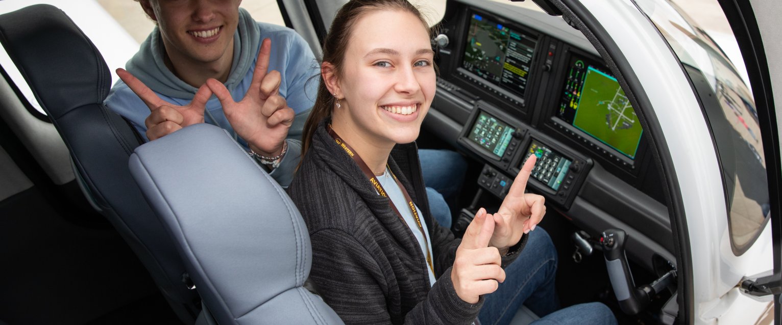 Two students sitting in Cirrus G7 plane