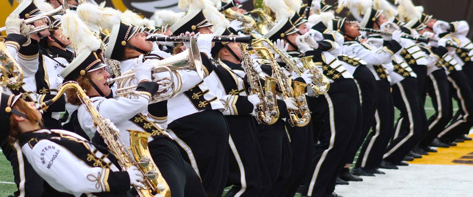 Bronco Marching Band playing energetically on the field.
