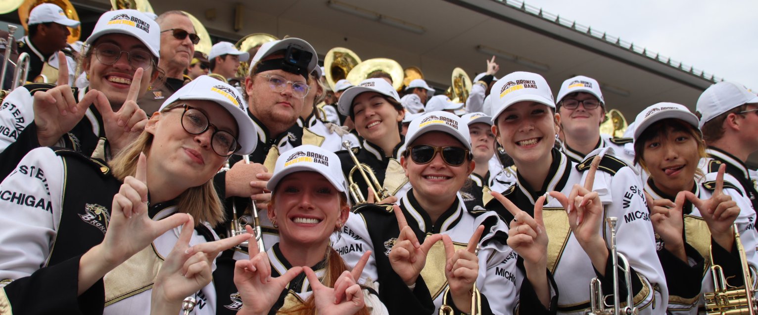 The Bronco Marching Band in Waldo stands with dubs up.