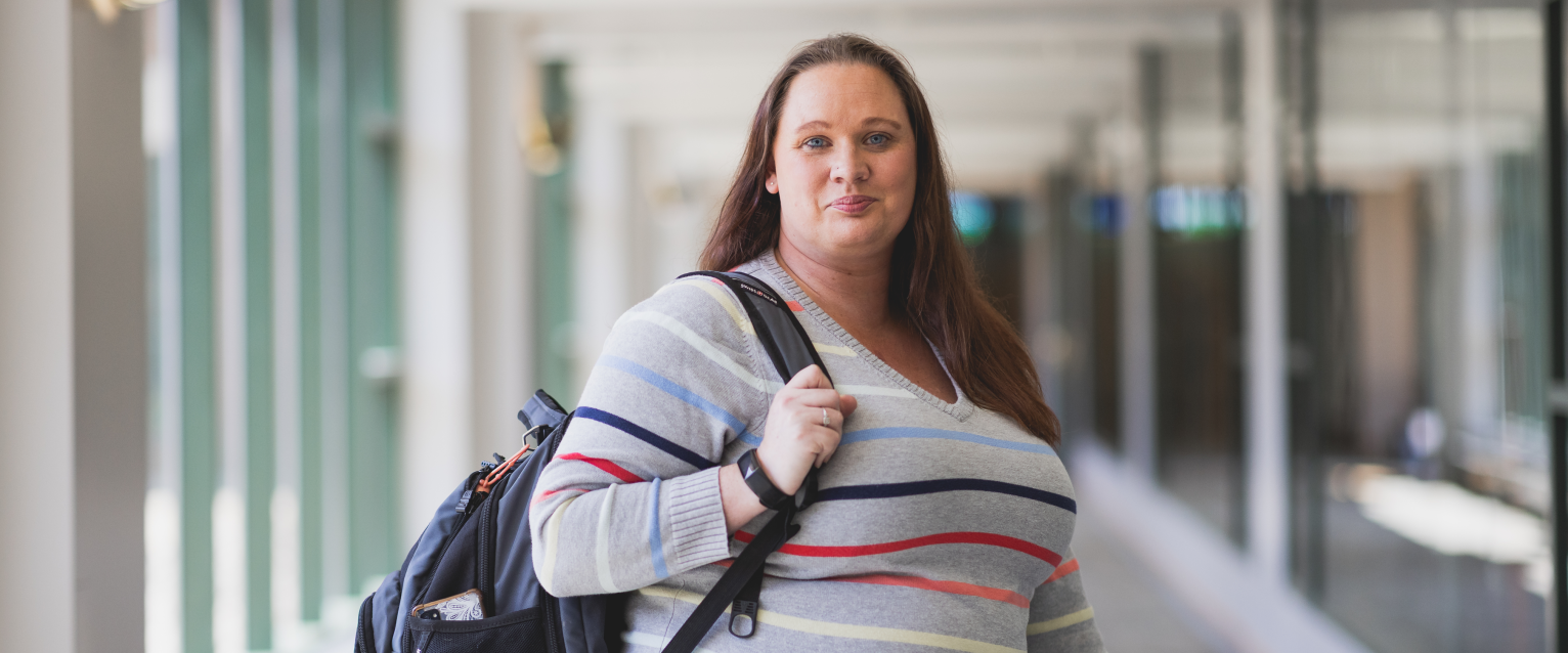 Janice August standing in the hallway of Schneider Hall
