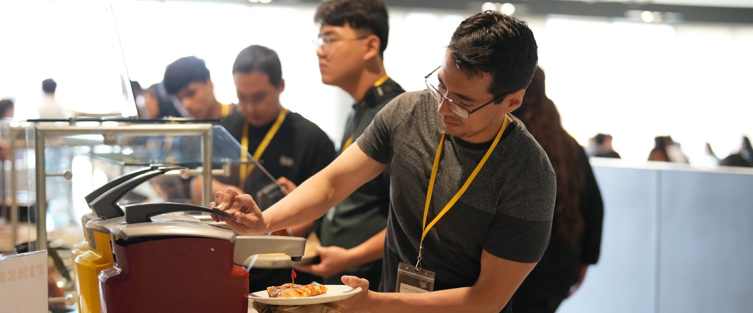 A student uses a ketchup dispenser in the Student Center Dining venue.