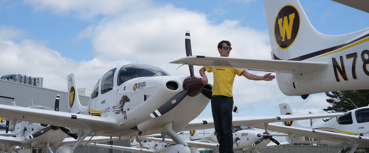 Planes at WMU with person waving them by.