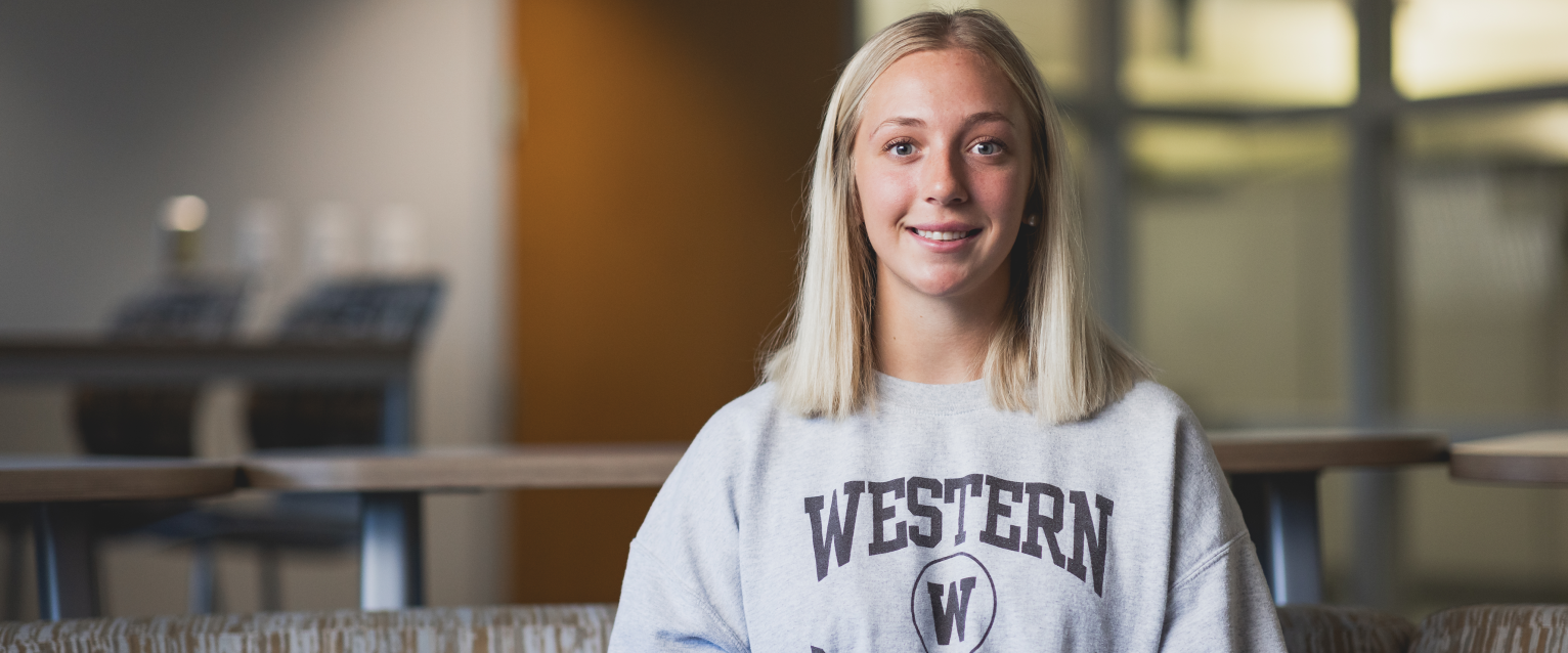 Leadership and business strategy student Abby Kovacevich seated in a conference room