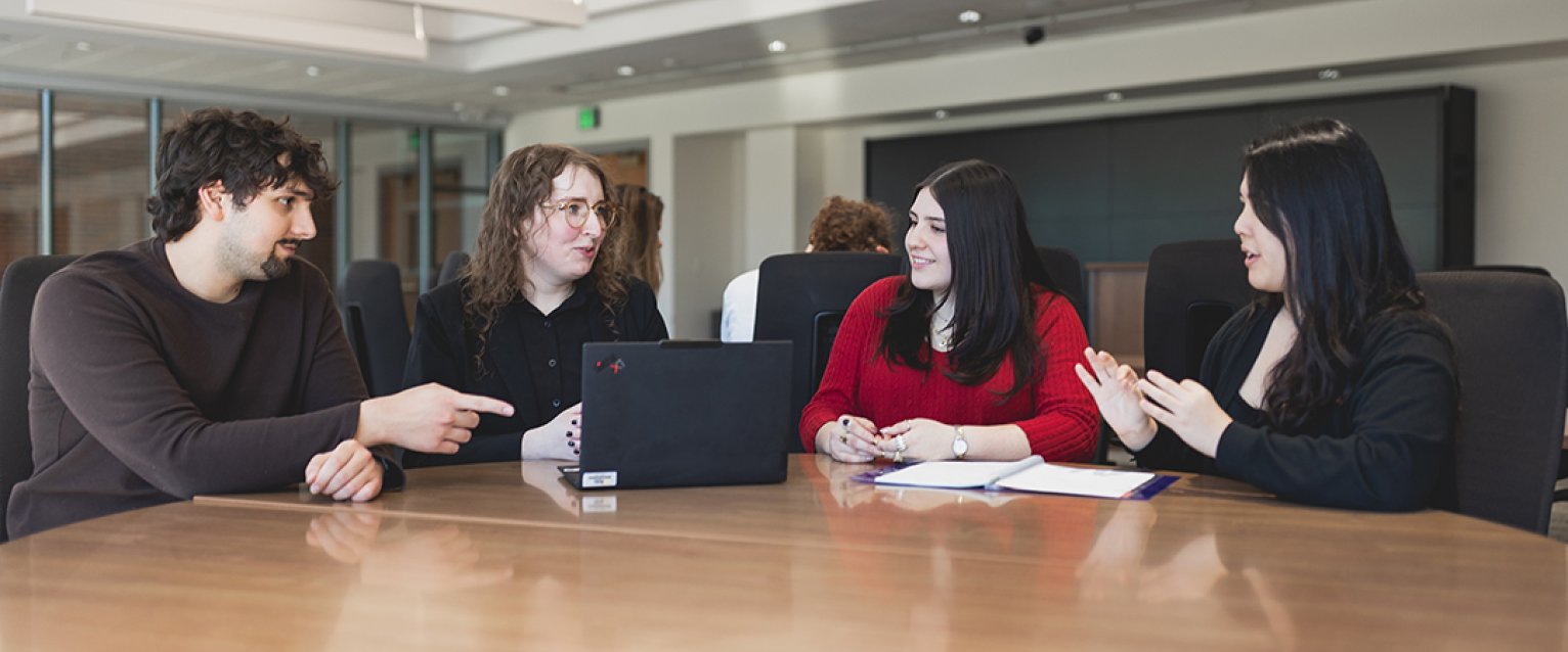A group of students and their professor at a table