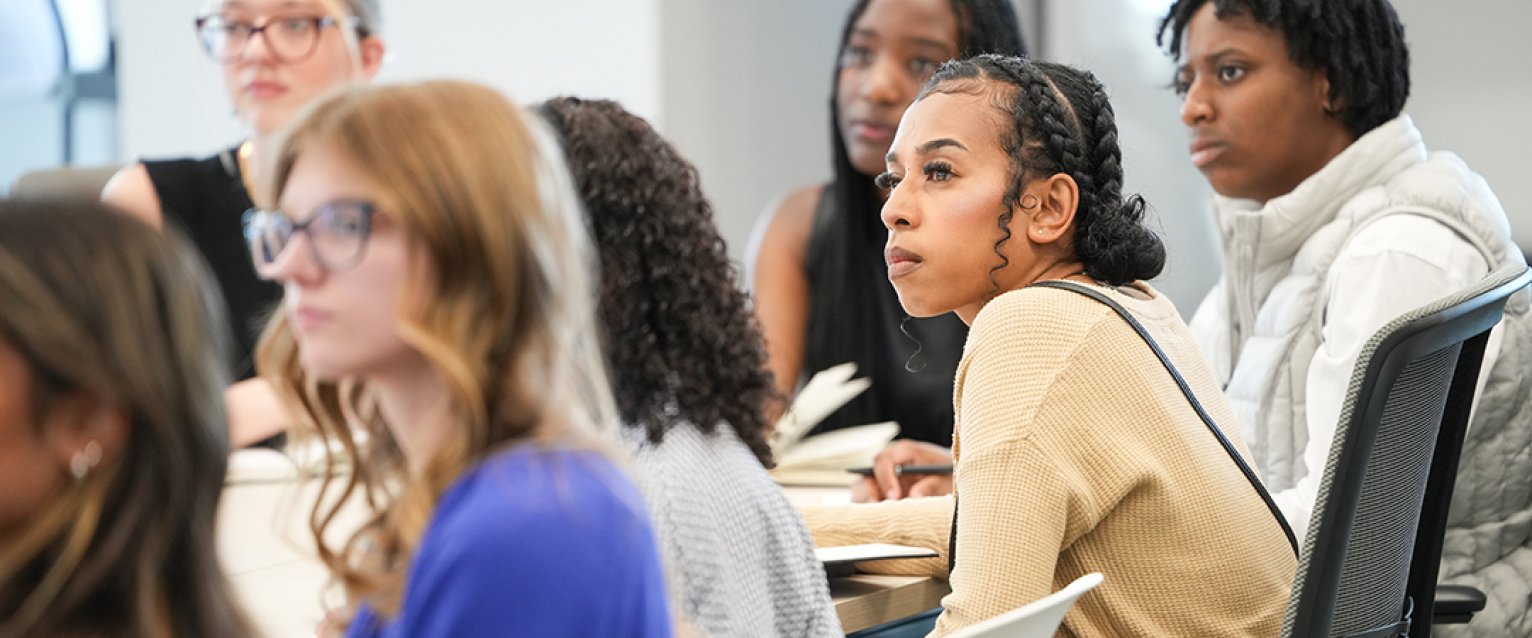 A line of students sitting and talking together
