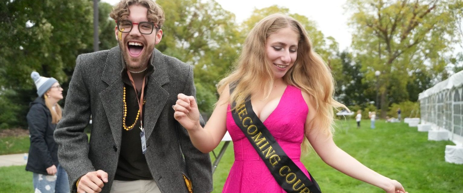 Two students participate in a Western Michigan University Homecoming event.