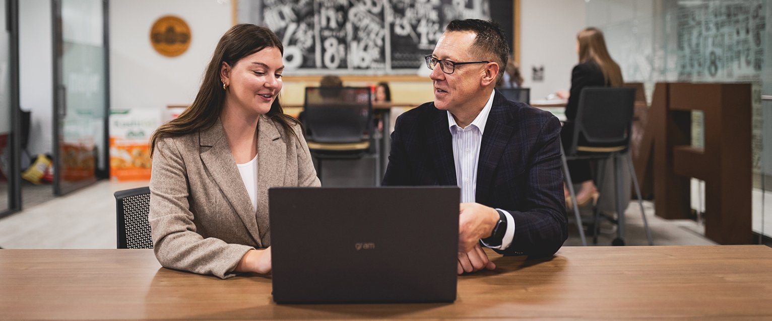 A student with her professor at a computer