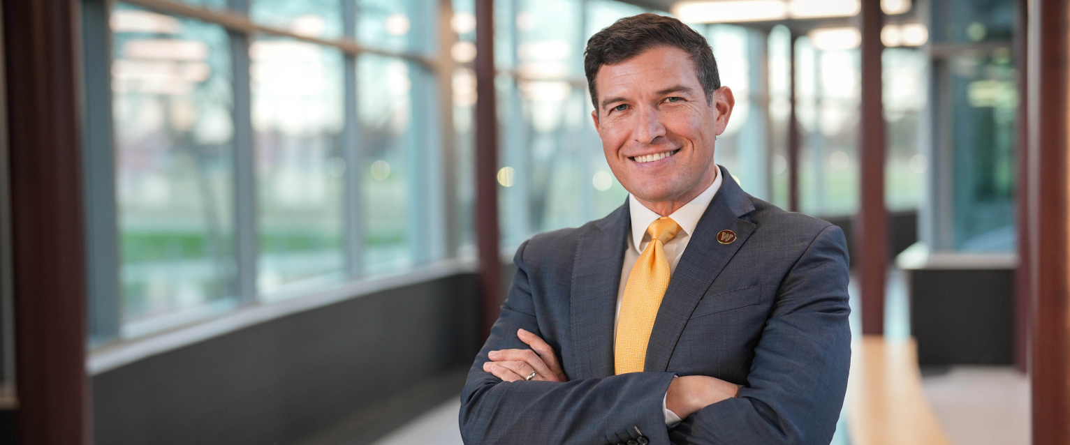 President Russ Kavalhuna poses for a portrait in the hallway of Floyd Hall.