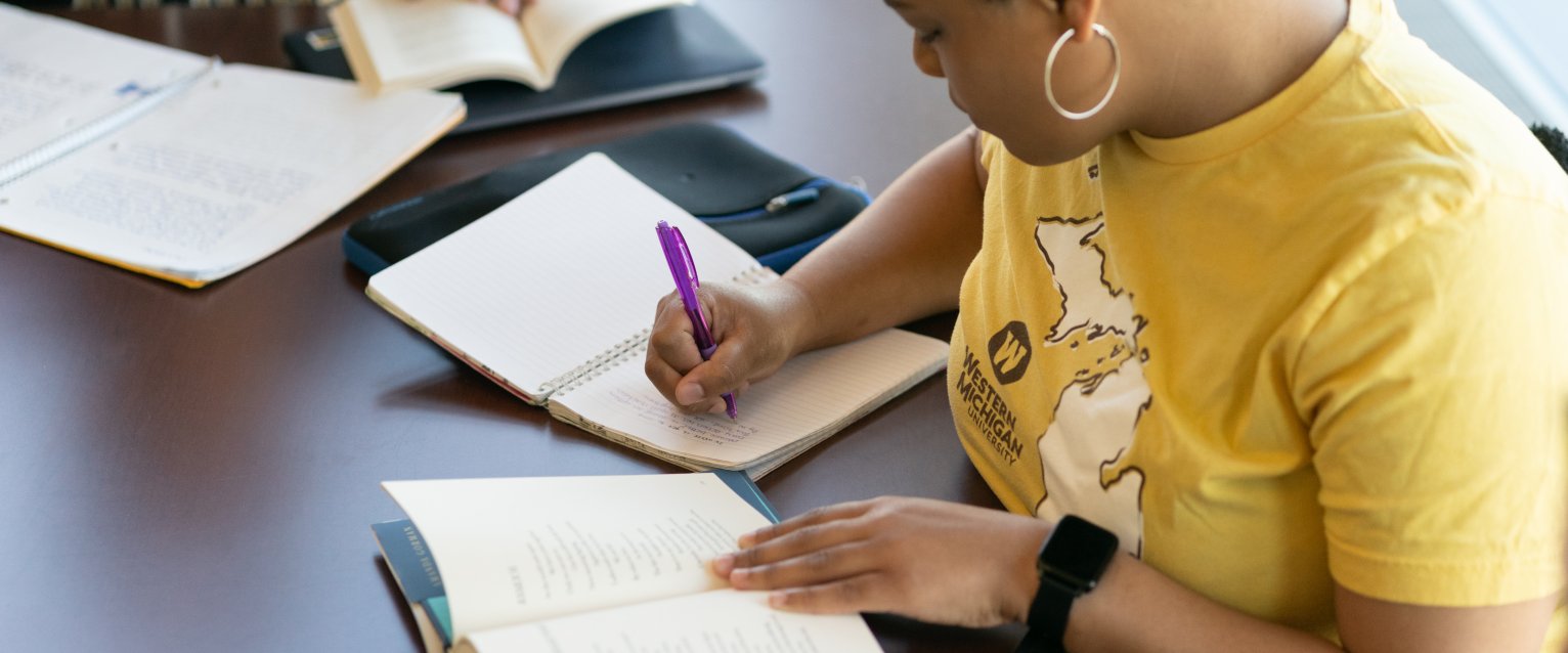 Student writing during creative writing course.