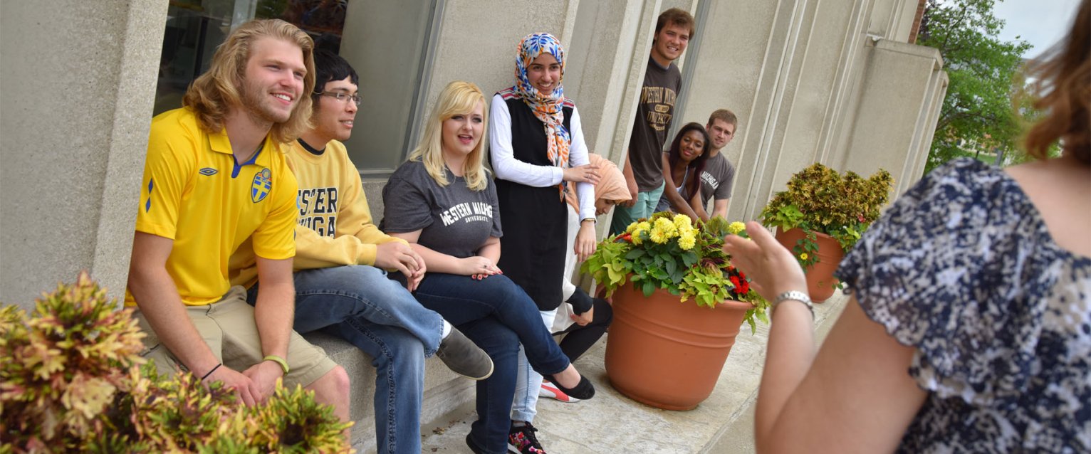 Students attending class outside on a sunny day.