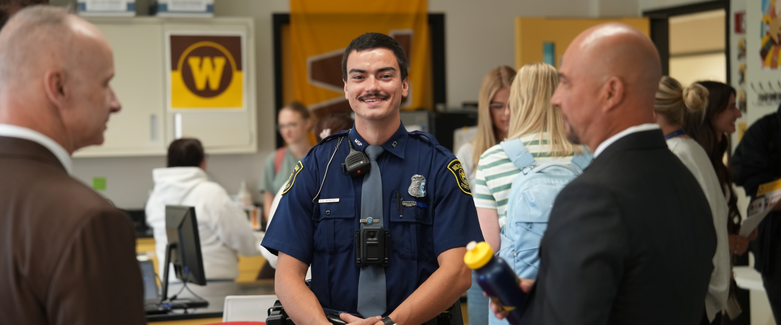 Trooper Sean Montroy stands in the Cold Case Program's lab on campus.