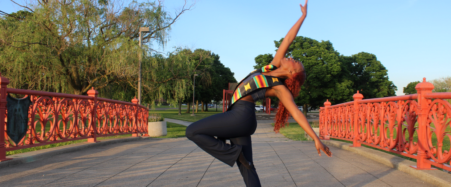 Shaniya Tate strikes a dance pose on a bridge.