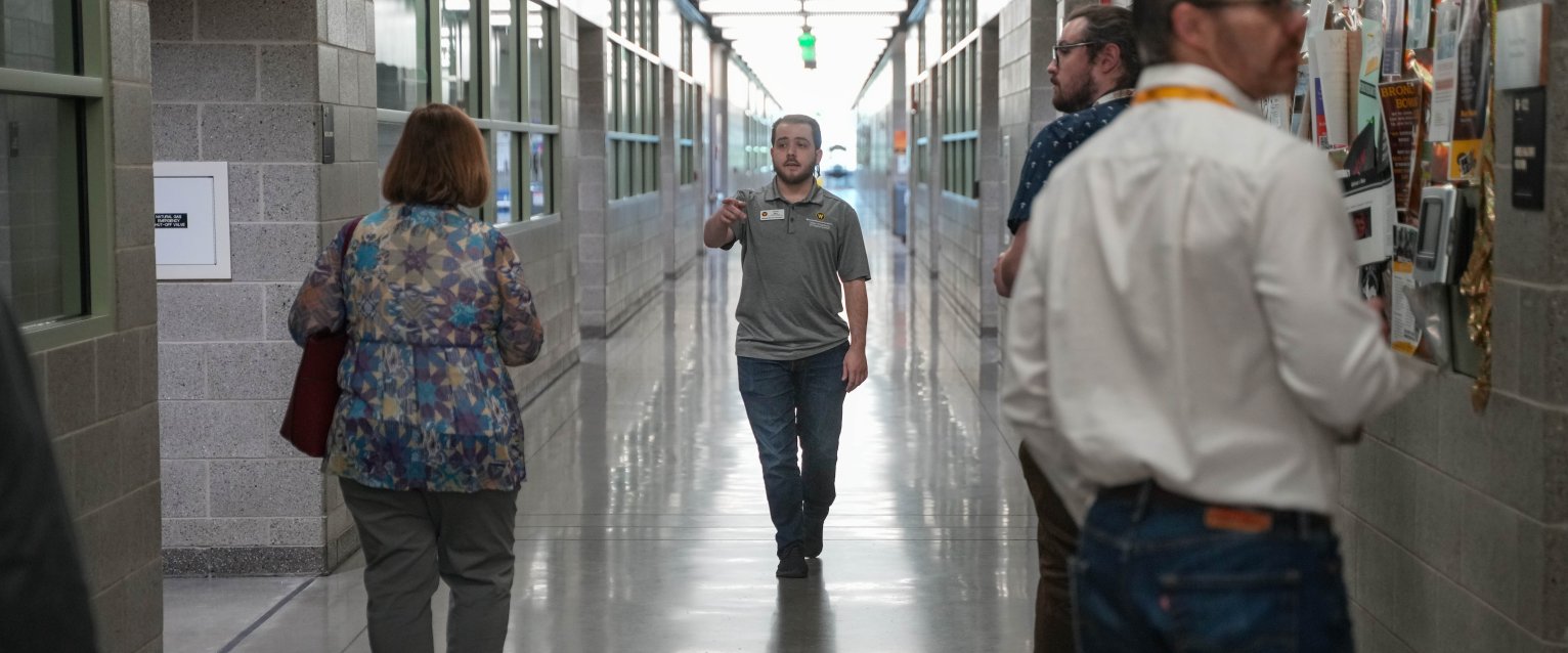 A tour guide showing visitors around Floyd Hall. 