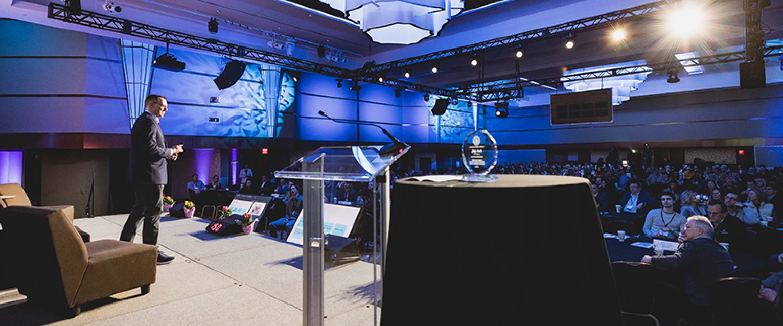 A professor presenting his research at a conference