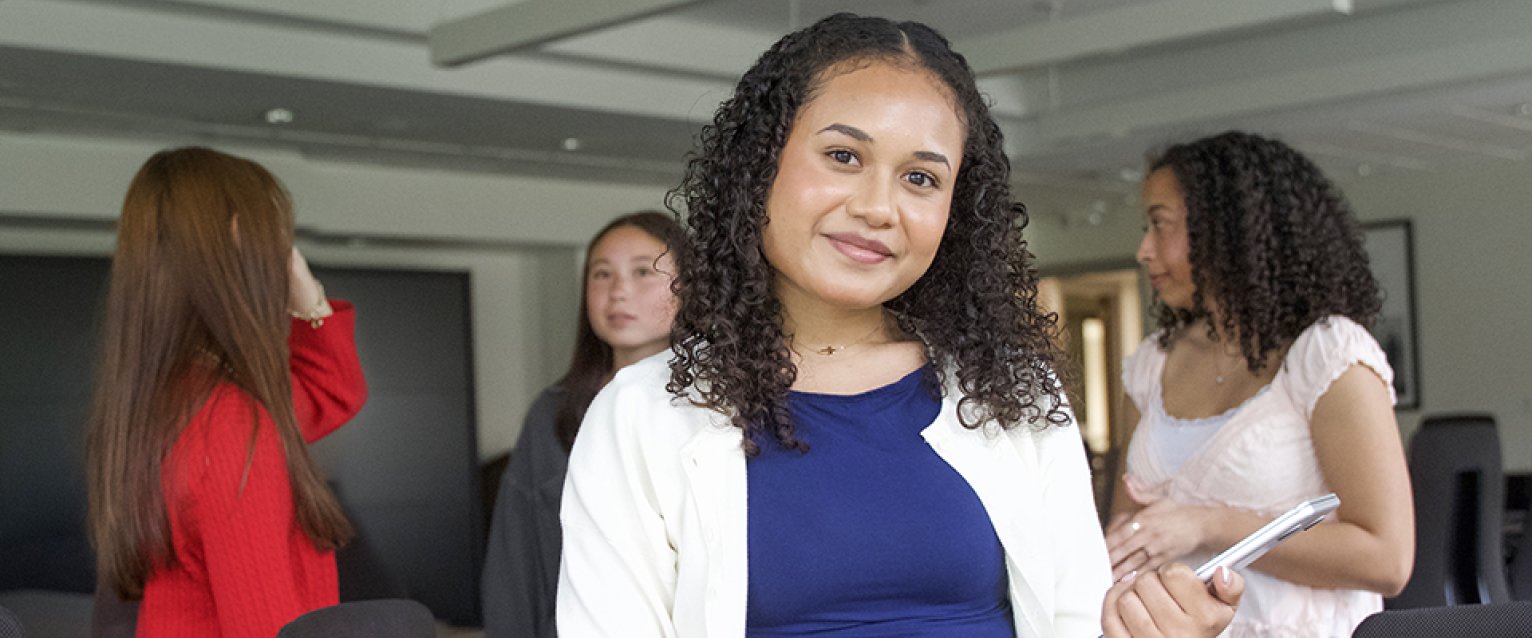 A student standing with a group of others