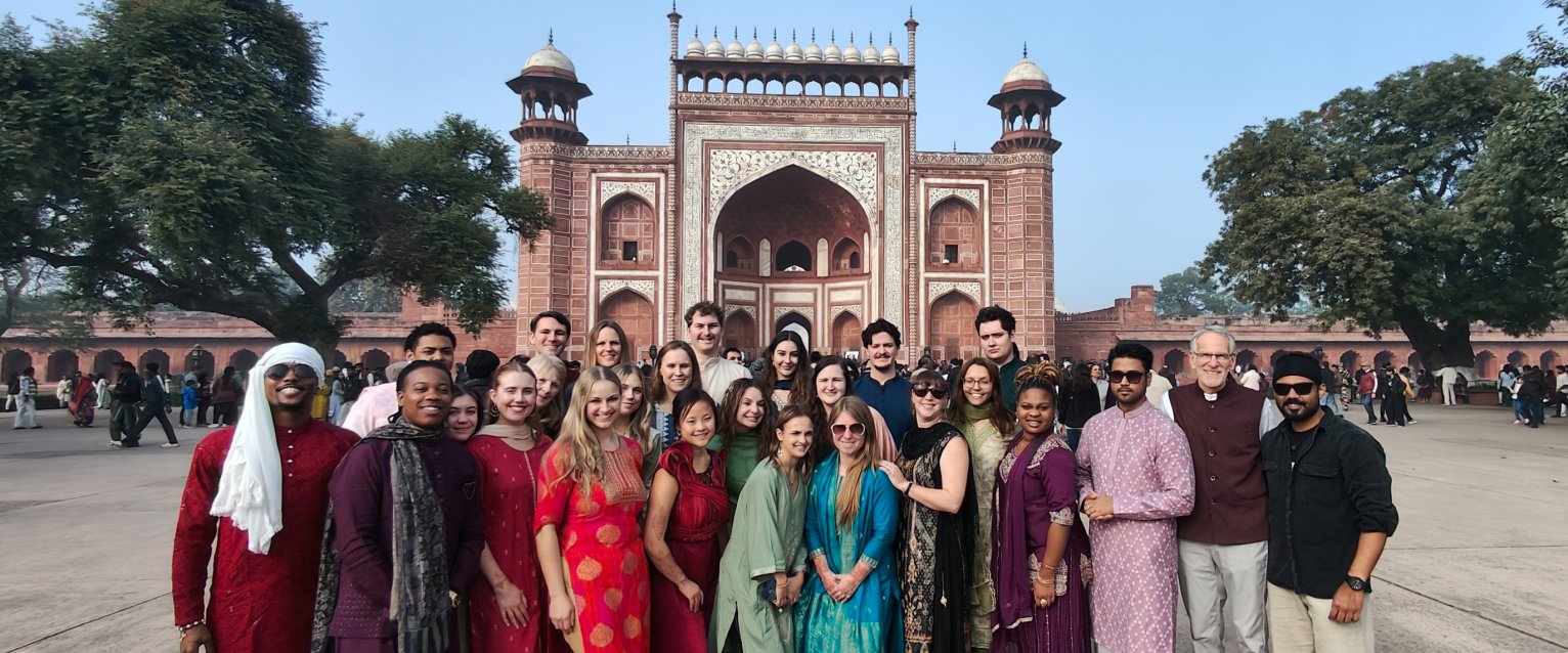 A group of students in front of Indian architecture in India 