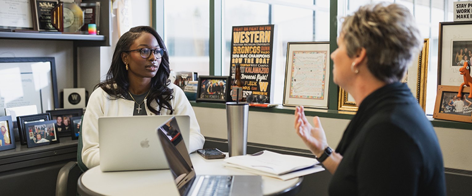 A student getting guidance from a professor