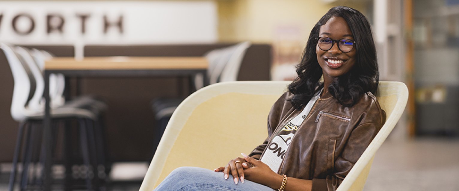 A marketing student sitting in a seat in the cafe