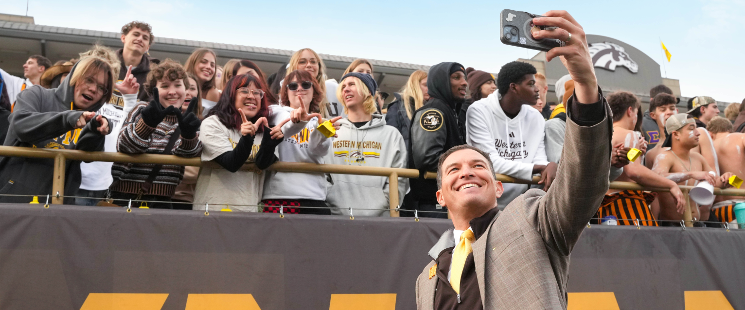 President Russ Kavalhuna takes a selfie with students in Waldo Stadium.
