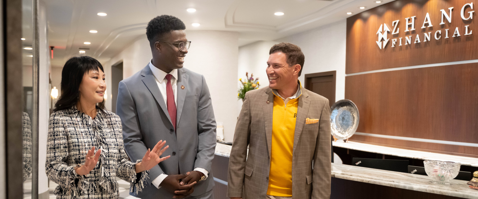 President Russ Kavalhuna walks through the lobby of Zhang Financial with Mo Tall and Lynn Chen-Zhang.