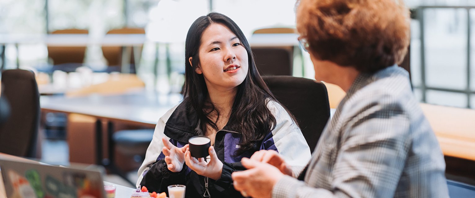 Student talking to her professor about her business ideas