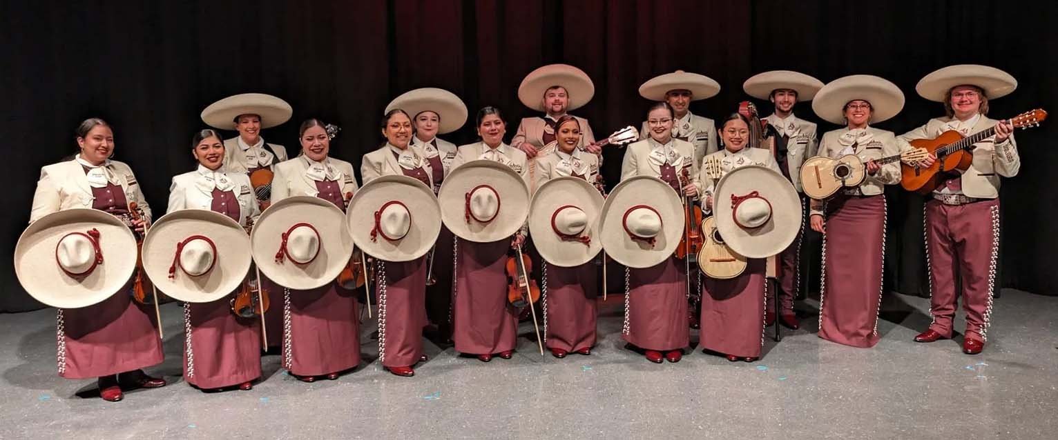photo of mariachi band with members holding instruments