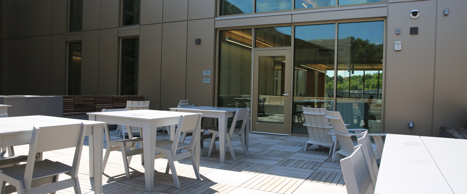 Modern outdoor seating in a Valley Oaks residence hall courtyard.