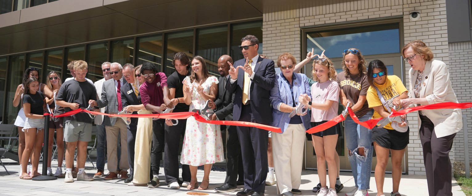 President Kavalhuna, WMU stakeholders and students cut the ribbon to mark the opening of Valley Oaks residence hall.