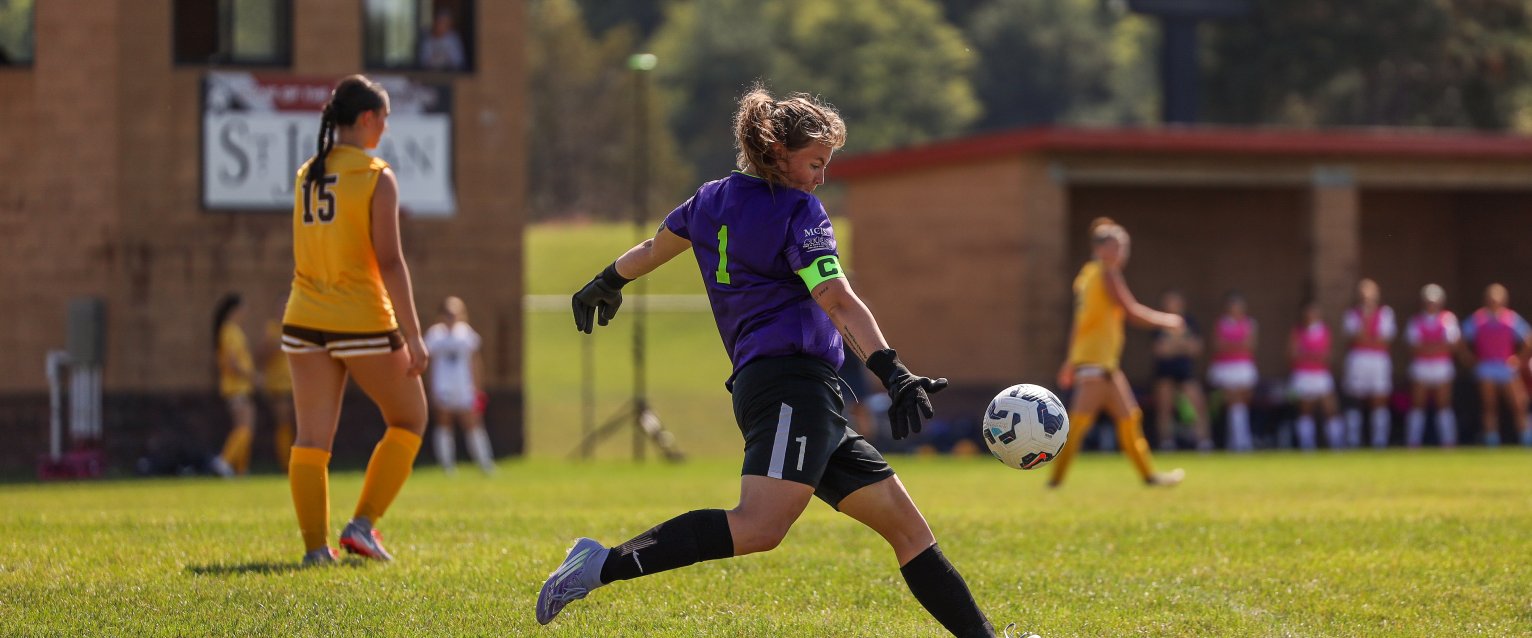 Women's club soccer member kicking a soccer ball