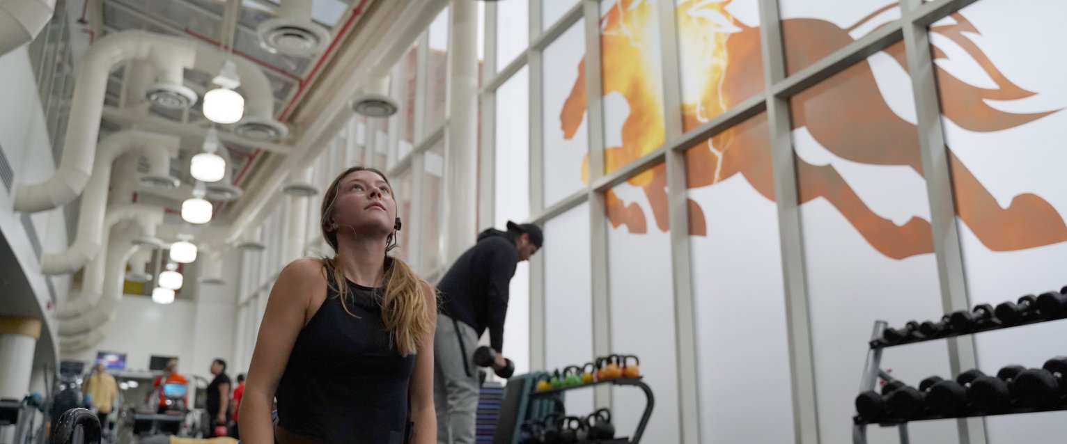 WMU Student stretching in the Student Recreation Center