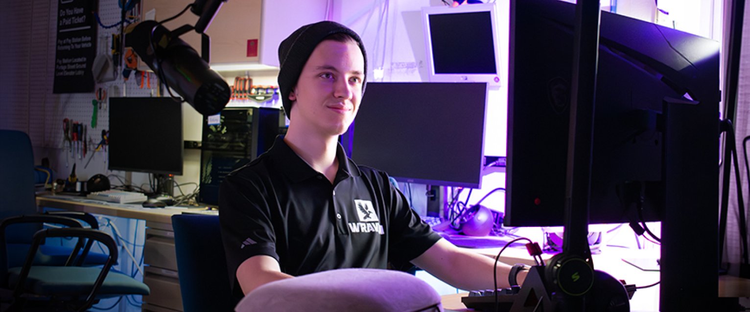 Business Info Systems student at a working computer with cool lights