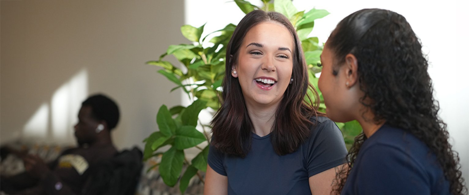 Two students discussing things happily