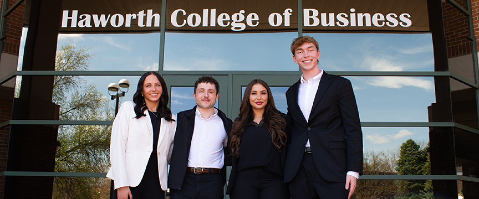 Digital Marketing students in front of the business college building