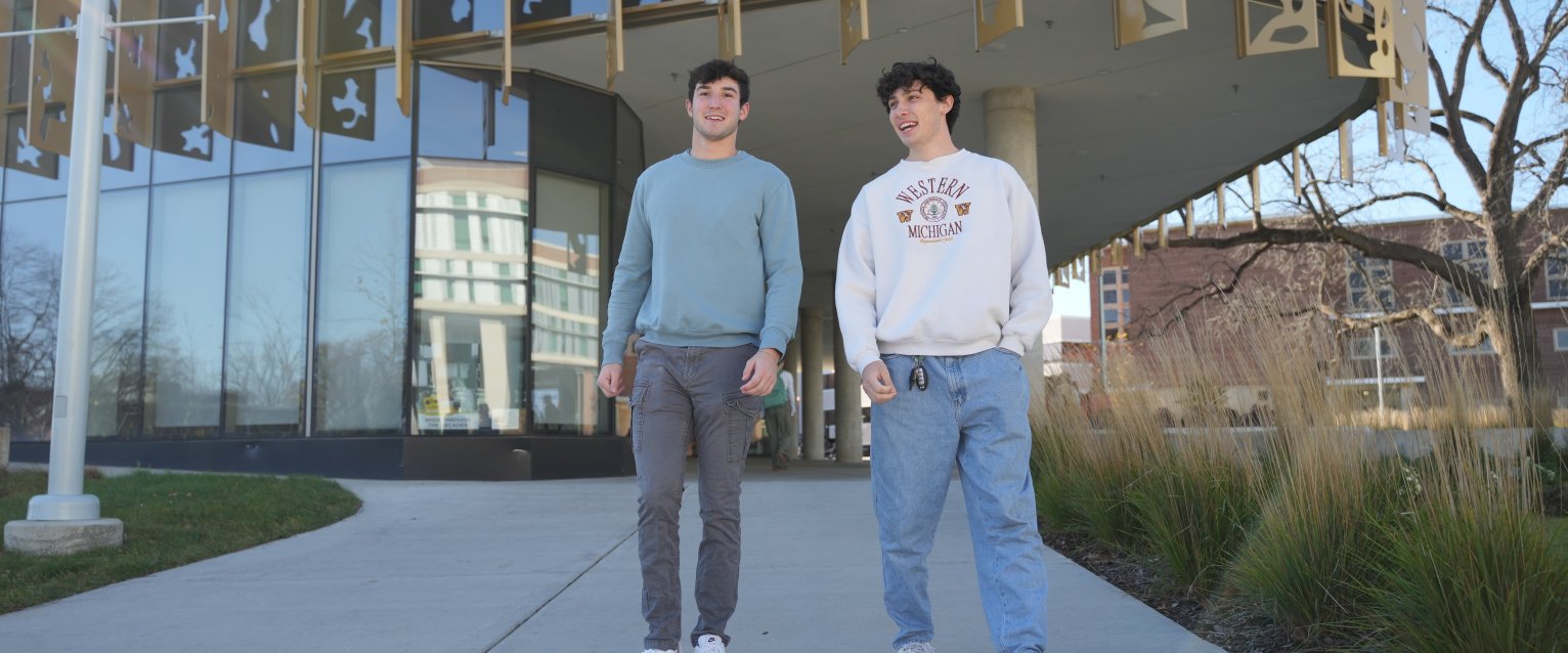Two students walk in front of Student Center.