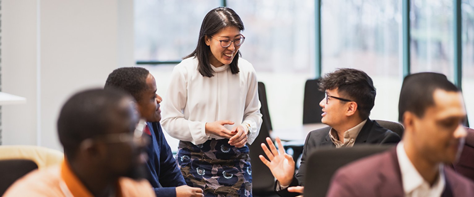 A professor talking to her students 