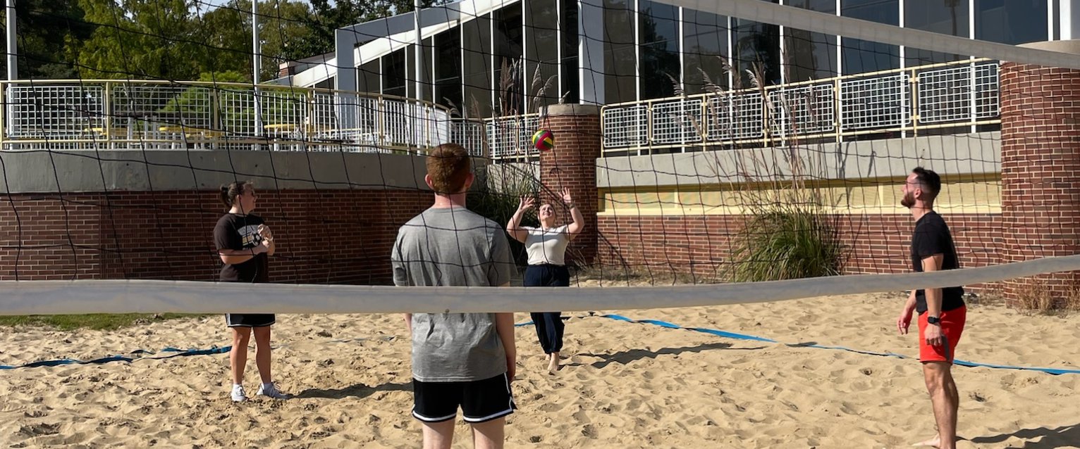 Group of student playing volleyball outside the Student Recreation Center