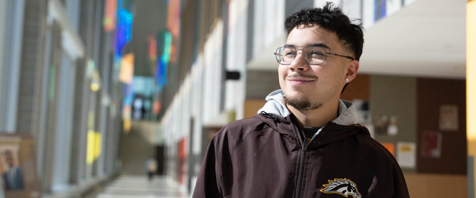 A student soaking up the sun inside Sangren Hall on WMU's Main Campus.
