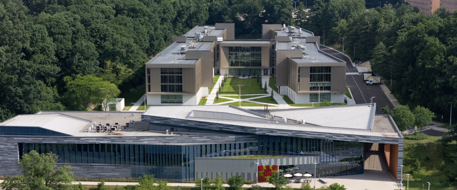 An aerial view of the Valley Dining Center and Valley Oaks residence hall surrounded by trees.