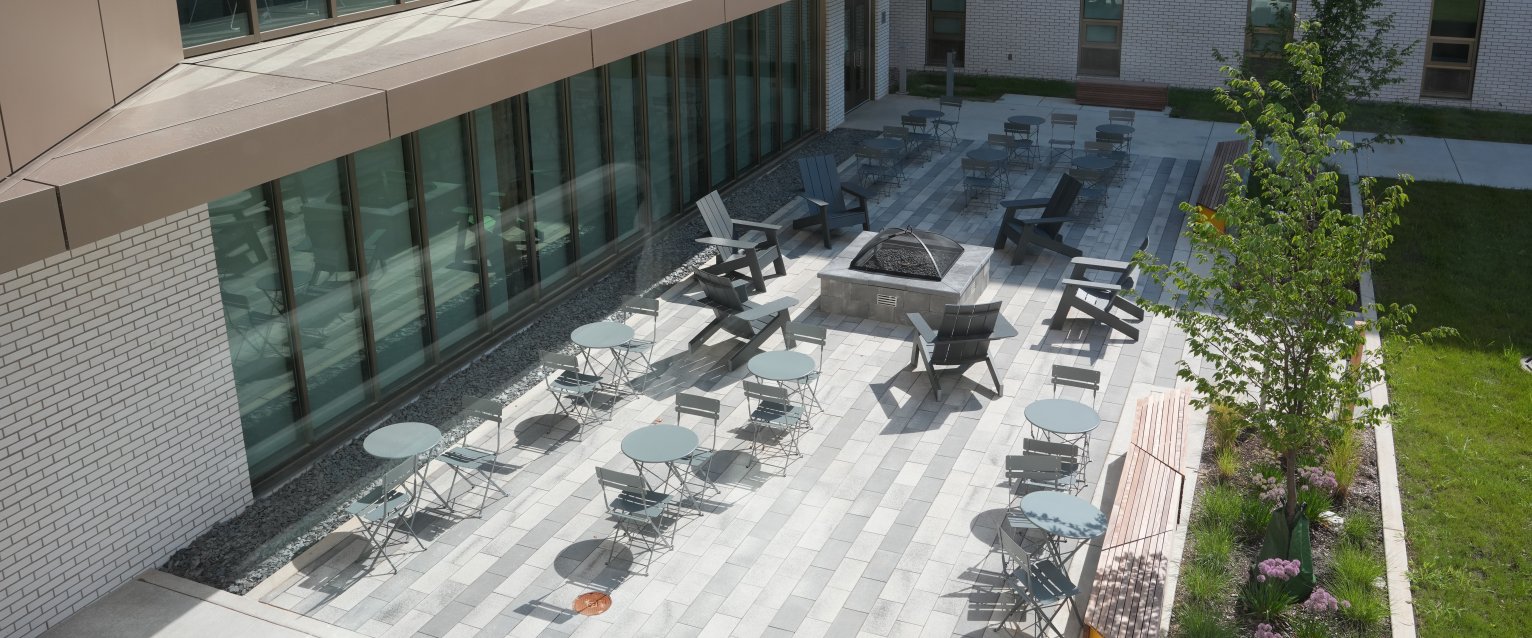 An aerial view of an outdoor courtyard at Valley Oaks with lounge seating and a fire pit.