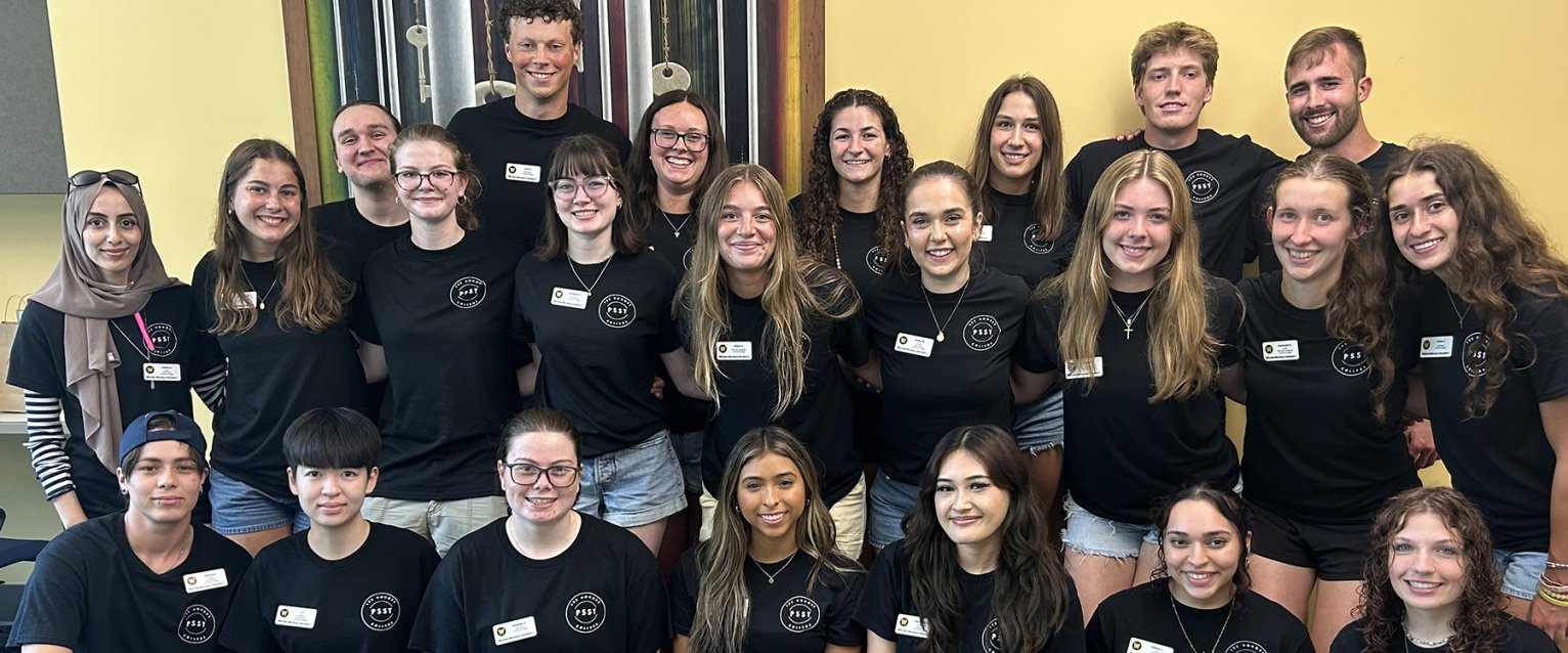 Group photo of the Lee Honors College Peer Student Success Team wearing their matching black PSST t-shirts.