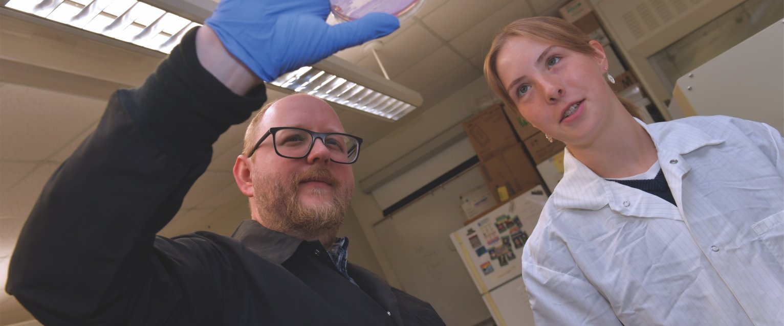 Koestler in lab with student
