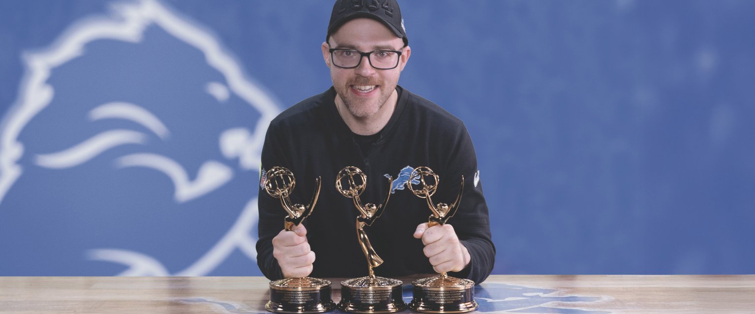 Maxwell Hahn of the Detroit Lions posing with his Emmy Awards.