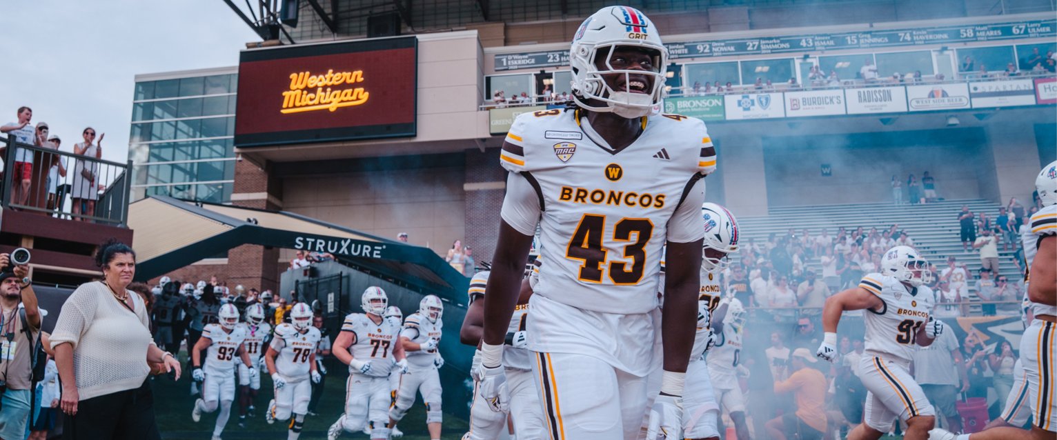 Western Michigan footballers run onto the field at Waldo Stadium before playing against—and beating—Monmouth.