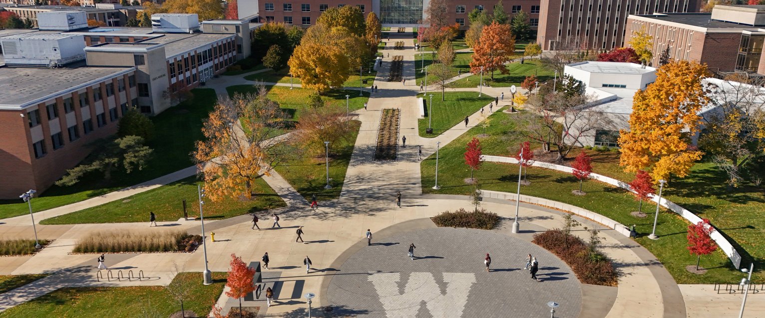 An aerial view of WMU's main campus with a W logo cement work in the center