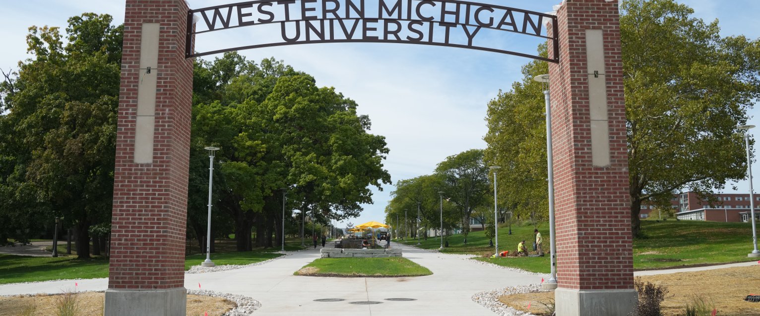 Image of Western Michigan University Entry gate with brick pillars and large trees