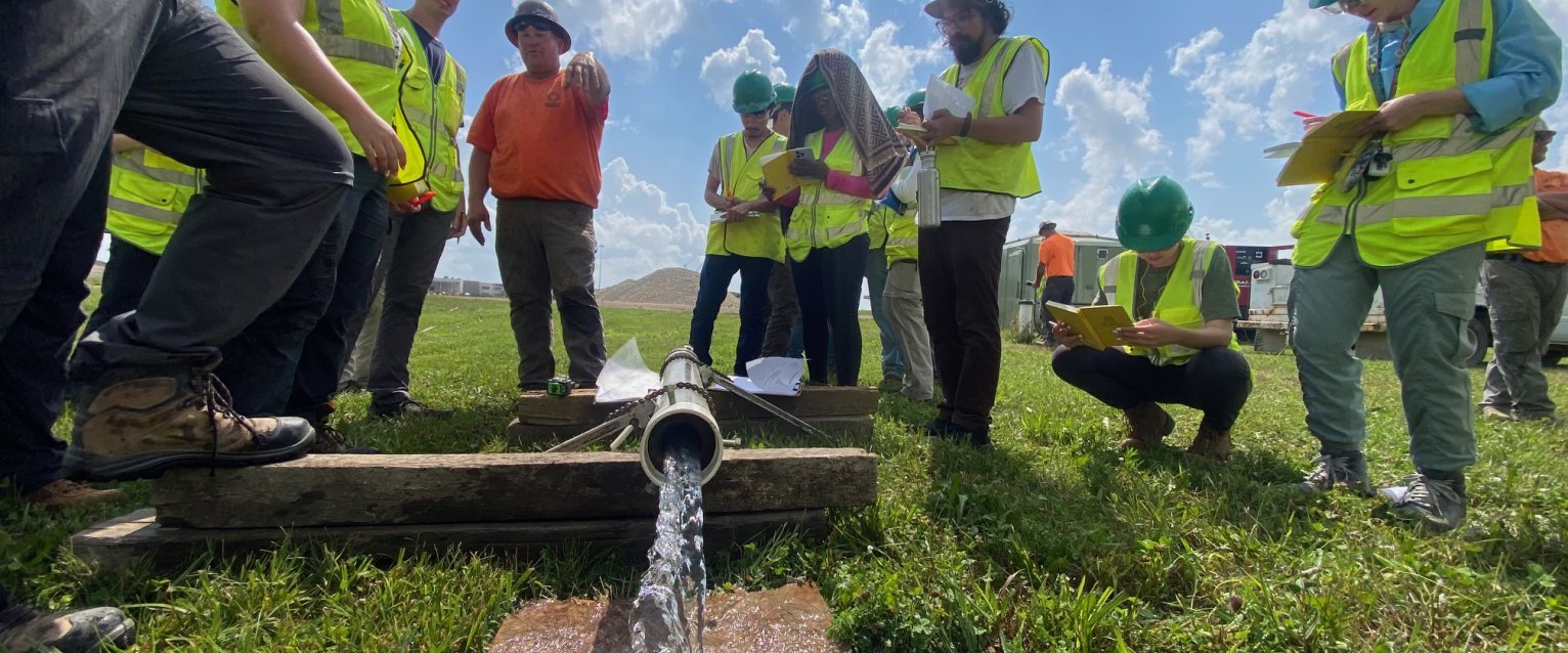 students conducting an aquifer pumping test