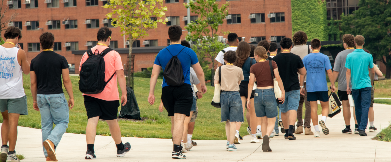 Students walking towards Ellsworth Hall on their tour