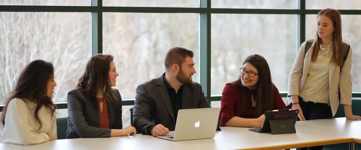 Students collaborating in dean's conference room