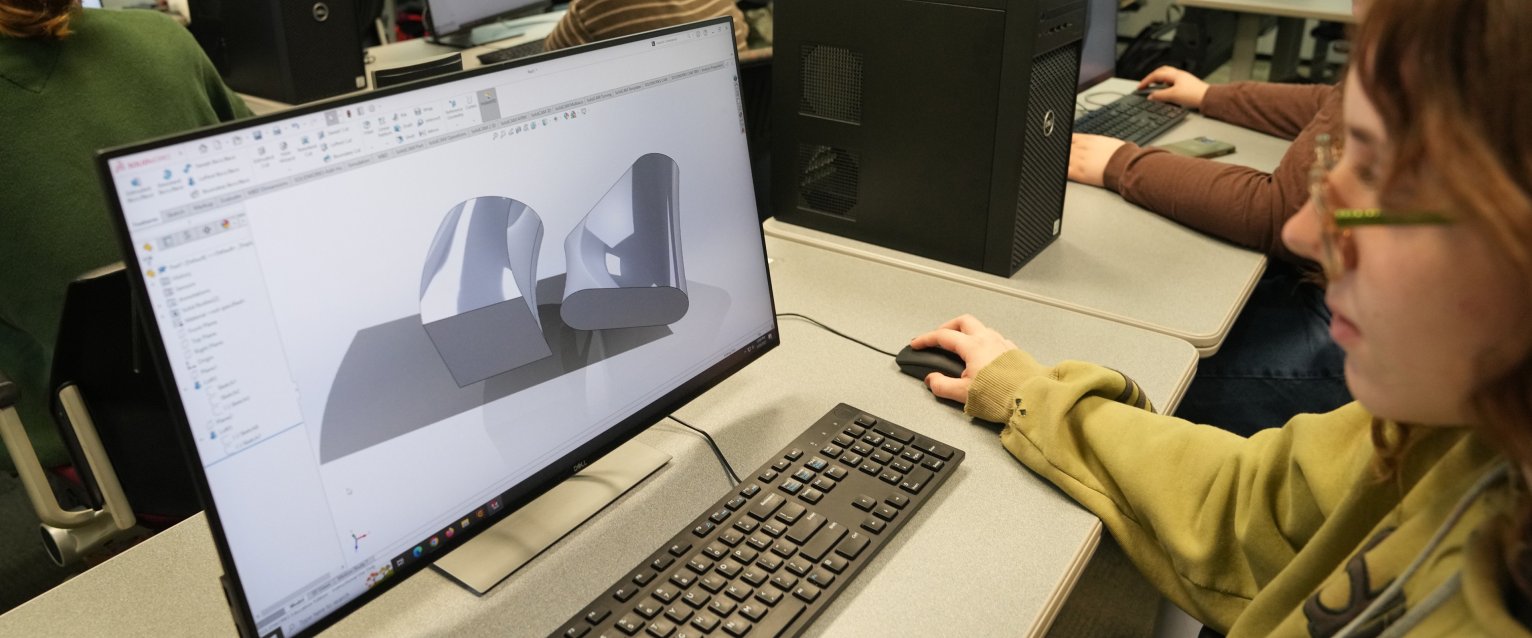 A computer engineering student on a laptop. 