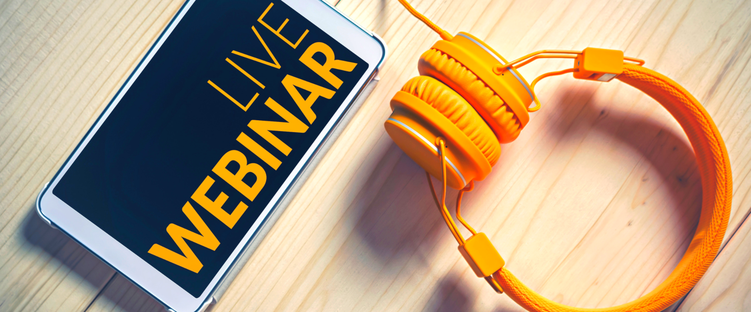 Phone with "live webinar" text and set of gold headphones